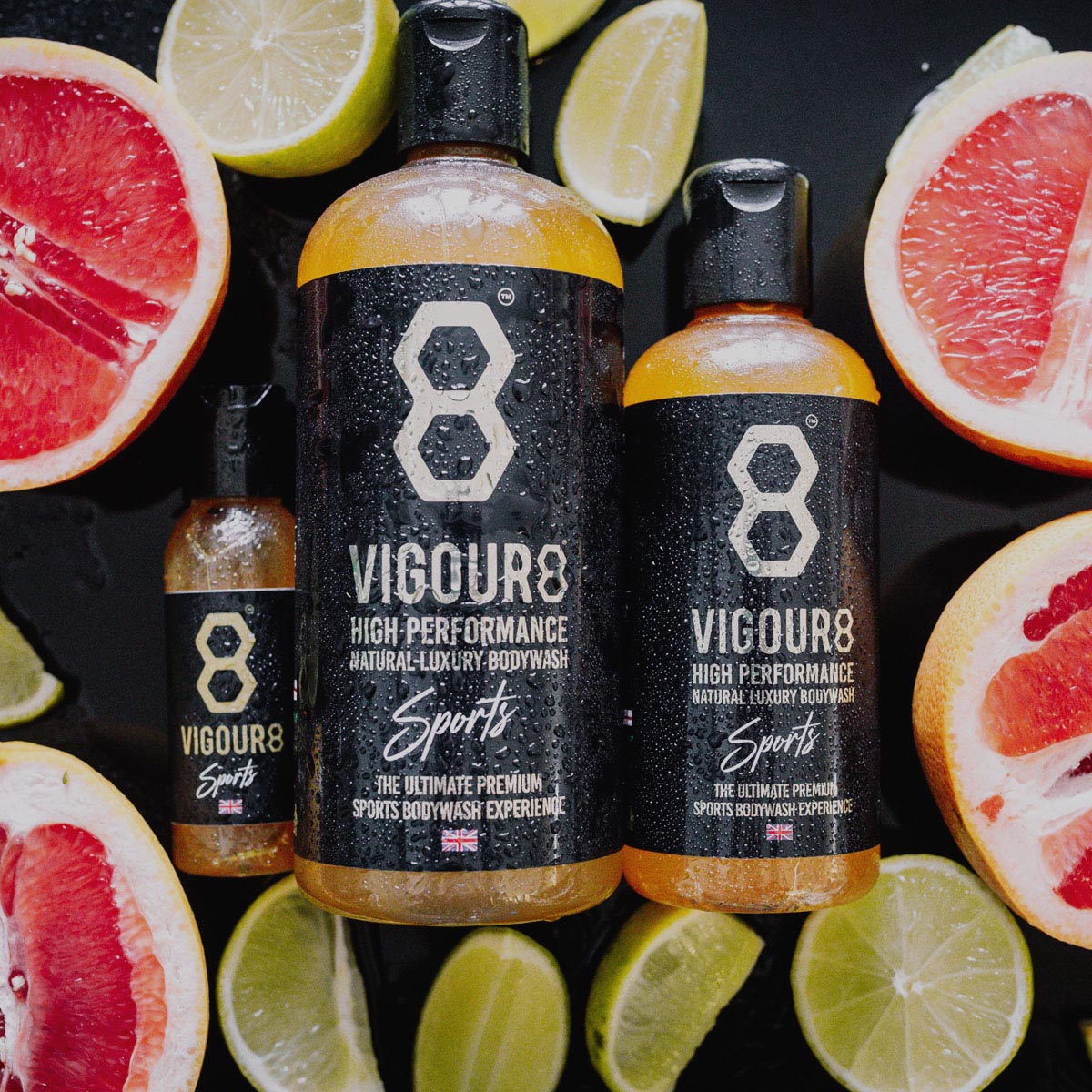 Vigour8 high performance body wash bottles with citrus fruits on a dark background